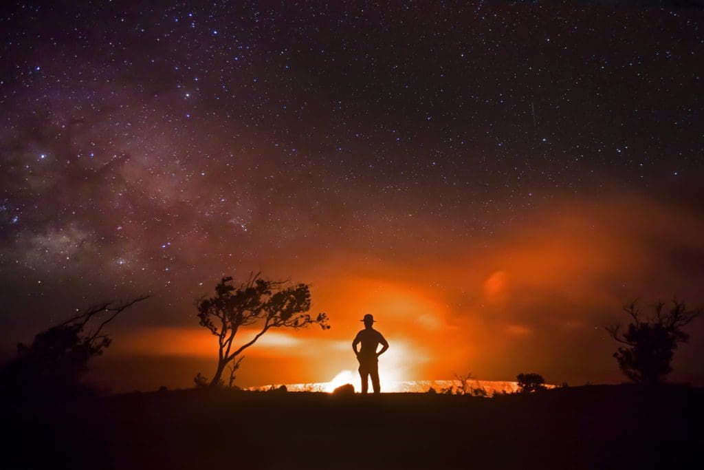 January 2021 - Park of the Month 8 Park Ranger and night sky with glowing volcano